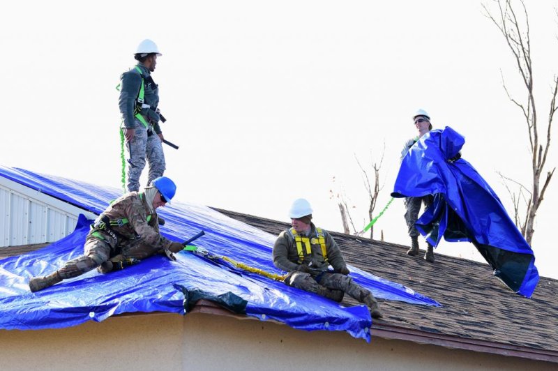 Members of the recovery task force place tarps on a roof to seal a building from further damage in the aftermath of Hurricane Michael hitting Tyndall Air Force Base. File Photo by Senior Airman Isaiah J. Soliz/U.S. Air Force