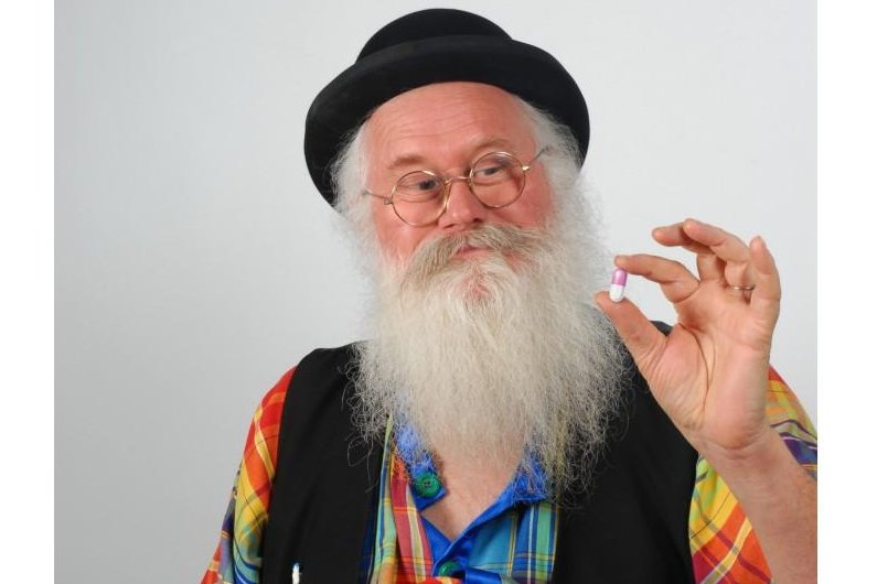 Christian Poincheval poses with one of his bodily gas-altering pills. Photo via <a class="tpstyle" href="http://www.pilulepet.com/en/">Pilulepet.com</a>