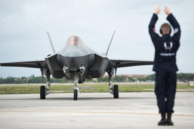Staff Sgt. Michael Couture, F-35 Heritage Flight Team crew chief, marshals an F-35A Lightning II upon arrival at the Miami-Opa Locka Executive Airport in Opa-Locka, Fla., on May 24, 2018. Photo by Airman 1st Class Alexander Cook/U.S. Air Force