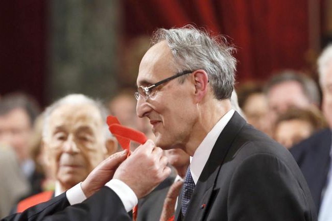 Bernard Bigot receives the Commander of the Legion d'honneur, France's highest civil award, during a ceremony at the Elysee presidential palace in Paris, on February 18, 2015. He said Wednesday a new test at the fusion reactor in Britain moves researchers one step closer to using it as a reliable energy source. File Photo by Patrick Kovarik/EPA