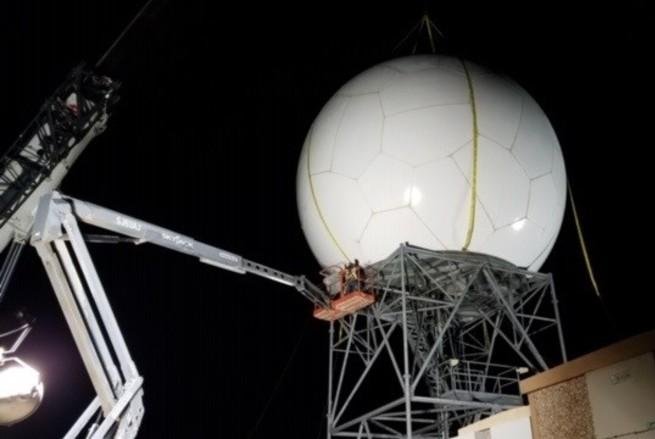 Contractors with Telecommunication Support Services Solutions, Inc. install a radome as part of refurbishments to a weather surveillance doppler radar on February 17 at Cannon Air Force Base, N.M. Photo courtesy of Telecommunication Support Services Solutions