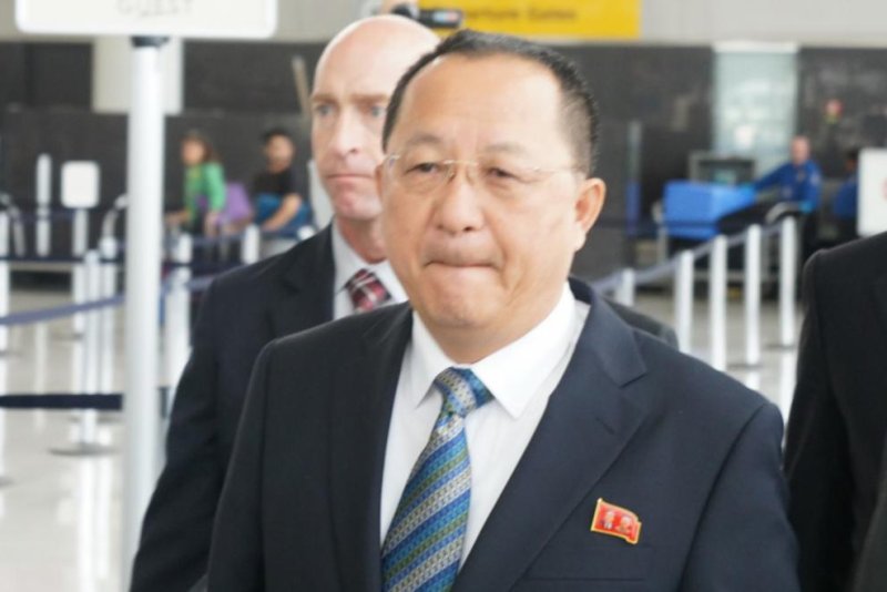 North Korean Foreign Minister Ri Yong Ho walk by reporters at John F. Kennedy International Airport on Wednesday. Ri is expected to deliver a speech at the U.N. on Friday. Photo by Yonhap