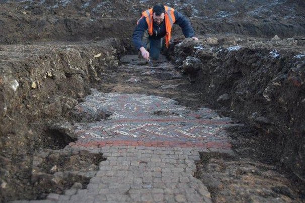 An ancient mosaic, which archaeologists say was part of a Roman villa and bathhouse, has been unearthed in southeast Britain as workers prepared the site for the construction of a supermarket. Photo courtesy of Oxford Archaeology
