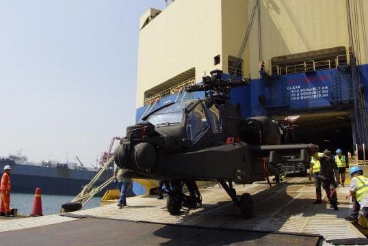 The first of 30 Apache AH-64E attack helicopters ordered by the country iss offloaded at a Korean port. Korean Ministry of Defense photo