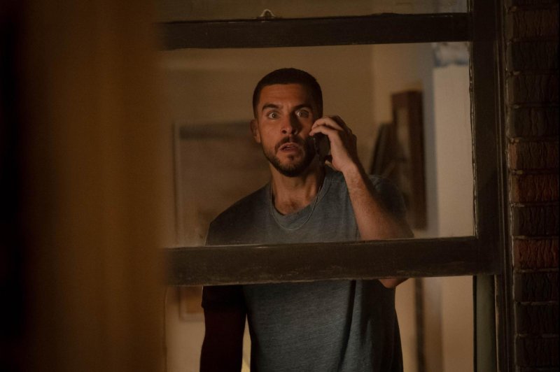 Danny (Josh Segarra) tries to warn his neighbors that Ghostface is in their apartment. Photo courtesy of Paramount Pictures