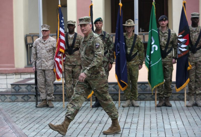 U.S. Army Gen. John Nicholson, pictured during a change of command ceremony in Afghanistan on March 2, 2016, told the U.S. Senate Armed Services Committee he needs thousands more troops in order to properly train and support Afghan forces as they continue working to clear the Taliban and other militants from towns and villages throughout the country. Photo by Rahmat Gul/EPA