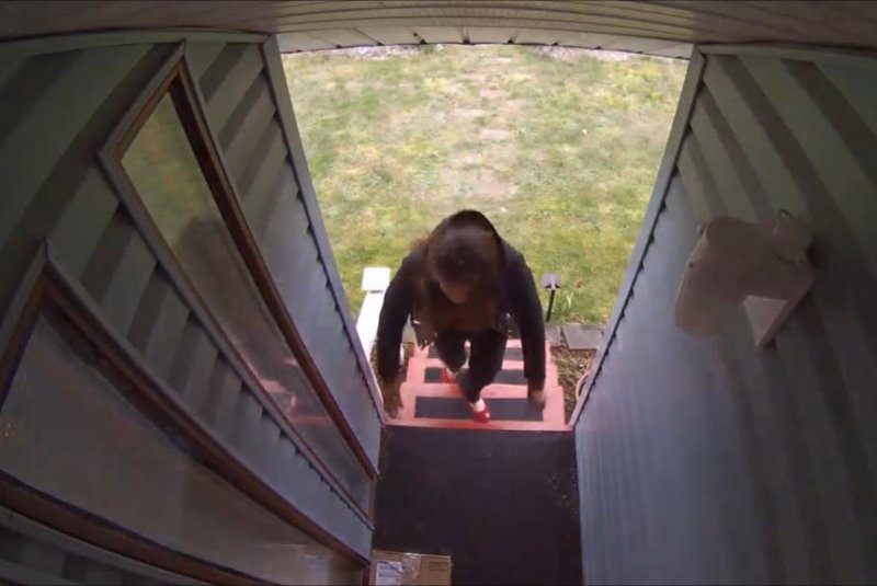 An attempted package thief is about to get a scare. Screenshot: Jaireme Barrow/YouTube