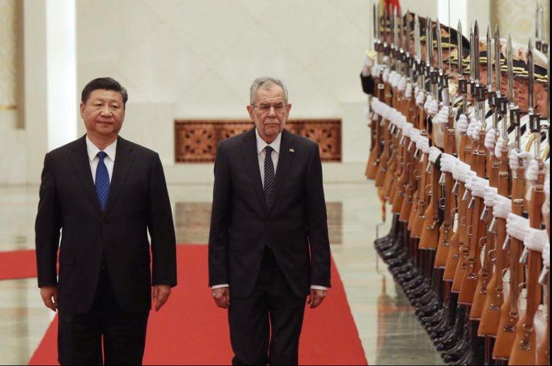 Chinese President Xi Jinping (L) and Austrian Federal President Alexander Van der Bellen (R) walk pass the People's Liberation Army honor guard during a welcome ceremony at the Great Hall of the People in Beijing on Sunday. China is expanding ties with European countries while building new free-trade zones. Photo by Wu Hong/EPA-EFE