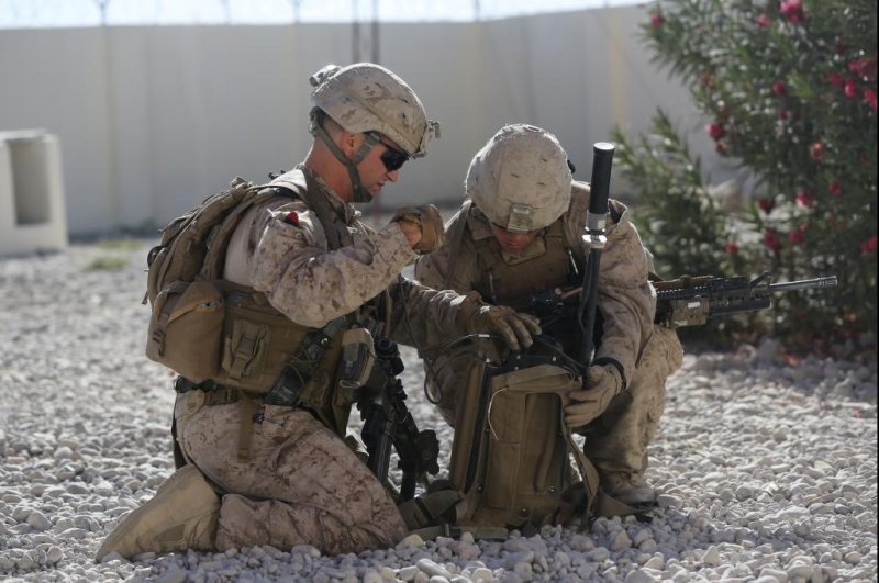 U.S. Marines set up a Thor II backpack-mounted counter improvised explosive device jammer during a local security patrol in Afghanistan. U.S. Marine Corps photo by Cpl. Corey Dabney