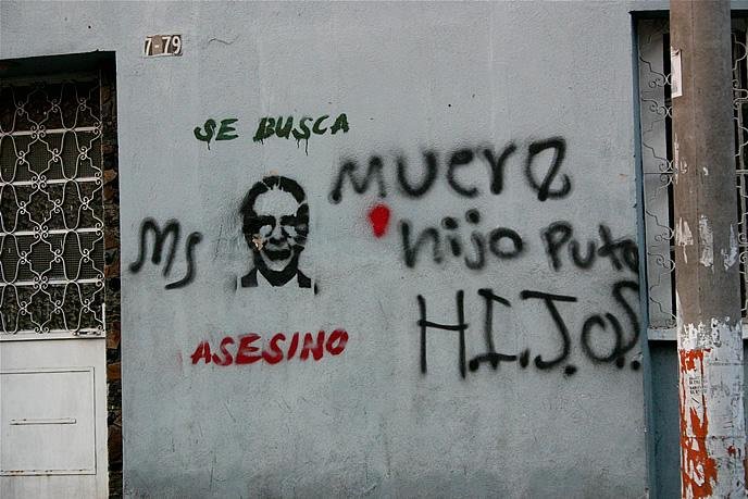 Former Guatemalan dictator Gen. Efraín Ríos Montt, 89, will face a genocide retrial in January. Pictured: Graffiti art in Guatemala of Ríos Montt where he is labeled as an "assassin." File Photo by Surizar/Flickr