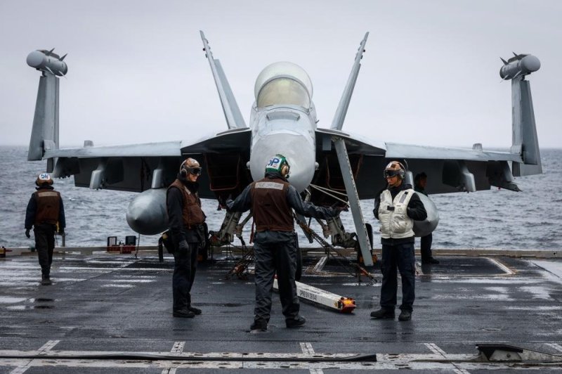 The pilot of an F/A-18 fighter jet who ejected Thursday night as the plane crashed near San Diego has died. The pilot has not been publicly identified and the investigation into the crash continued Friday. Navy service members maintain an F/A-18 fighter jet on deck during an exercise on the USS Gerald R. Ford aircraft Carrier in the eastern Atlantic Ocean, on Nov. 13, 2022. File Photo by Stephanie Lecocq/EPA-EFE