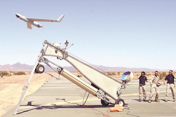Sgt. Michael Kropiewnicki, a U.S. Marine Corp combat videographer, launches a ScanEagle unmanned aerial system during an exercise at Yuma, Ariz., in 2006. Photo by by Sgt. Guadalupe Deanda/U.S. Marine Corps