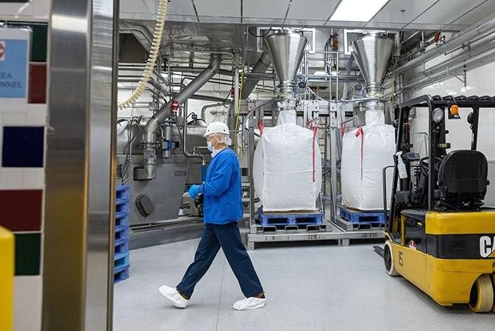 An Abbott employee working inside a production area of the Michigan infant formula manufacturing facility wears shoe covers to help prevent outside particles from entering production areas. Photo courtesy of Abbott