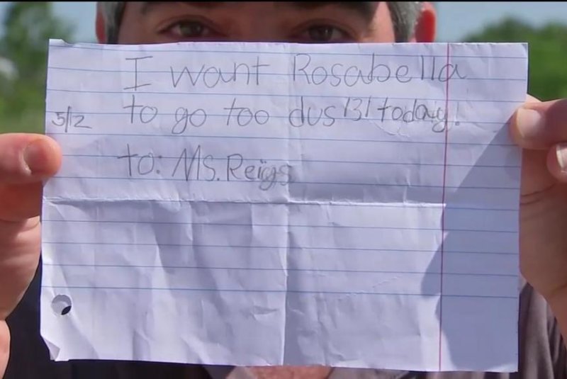 Charlie Dahu shows off the forged note his daughter, Rosabella, 7, used to fool teachers into allowing her to ride the bus home instead of staying for an after school program. Screenshot: KTRK-TV