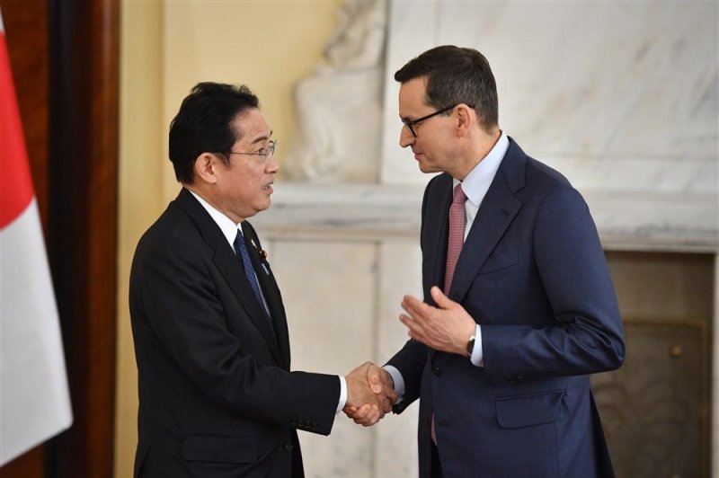 Polish Prime Minister Mateusz Morawiecki (R) and Japanese Prime Minister Fumio Kishida (L) shake hands during a joint press conference after their meeting in the Chancellery of the Prime Minister, in Warsaw, on Wednesday. Photo by Radek Pietruszka/EPA-EFE