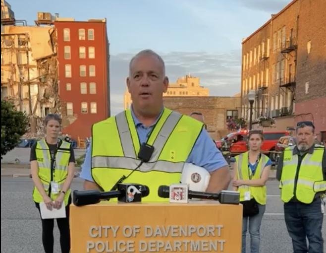 Davenport fire chief Mike Carlsten speaks to reporters before the apartment building on 324 Main Street that collapsed shortly before 5 p.m. Sunday. Screen capture courtesy of City of Davenport
