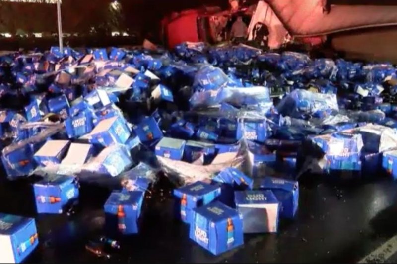 A delivery truck carrying cases of Bud Light overturned after a collision, leaving cases of beer strewn about a Long Island road on Wednesday morning.  Screen capture/NBC New York