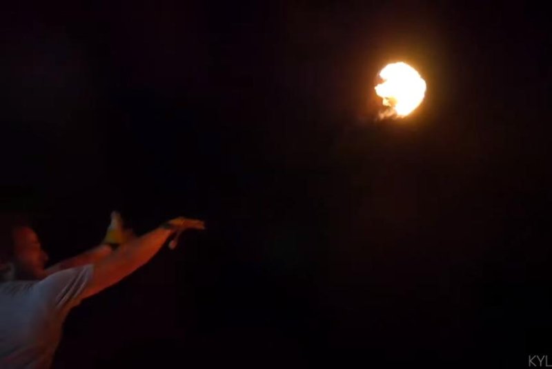 A man shoots a flaming basketball toward a nearby hoop. Will he make the shot? (Yes.) Screenshot: Storyful