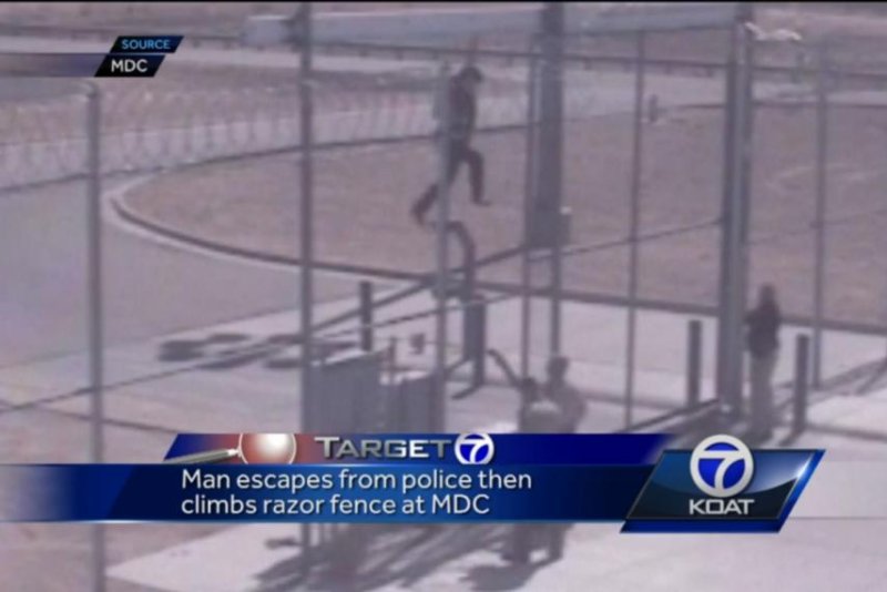 Joseph Maestas climbs a fence to escape from the Metropolitan Detention Center in New Mexico. Screenshot: KOAT-TV