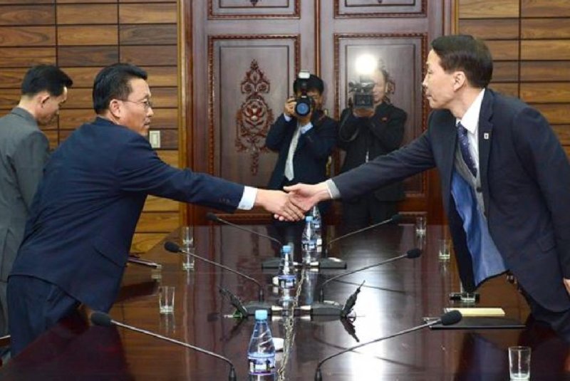 North Korean delegate Hwang Chol, left, shakes hands with Kim Ki-woong, director-general of the Unification Ministry's Special Office for Inter-Korean Dialogue. Photo Courtesy of Republic of Korea Ministry of Unification