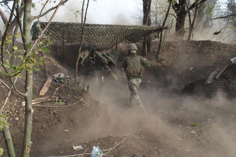 A Ukrainian soldier fires on a Russian position along the Donetsk frontline. Photo by Patrick Hilsman/UPI