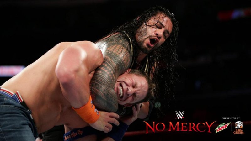 Roman Reigns (L) locks down John Cena during their match Sunday at WWE No Mercy. Photo courtesy of WWE/Twitter