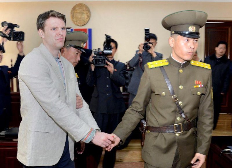 Otto Warmbier (L) is seen heading to his March 16, 2016, trial in Pyongyang, North Korea. The U.S. citizen was sentenced to 15 years of hard labor for stealing a propaganda poster. He was released on Tuesday. Photo courtesy of Korea Central News Agency/EPA
