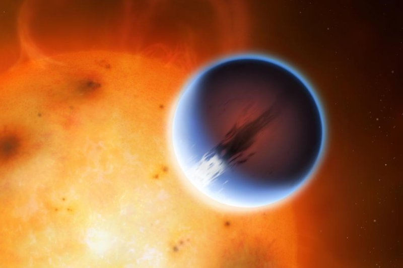 The day side of the exoplanet likely looks blue, as light becomes scattered from the atmosphere's silicate haze. The planet's high temperature causes the night side to glow a deep red. Photo by Mark A. Garlick/University of Warwick