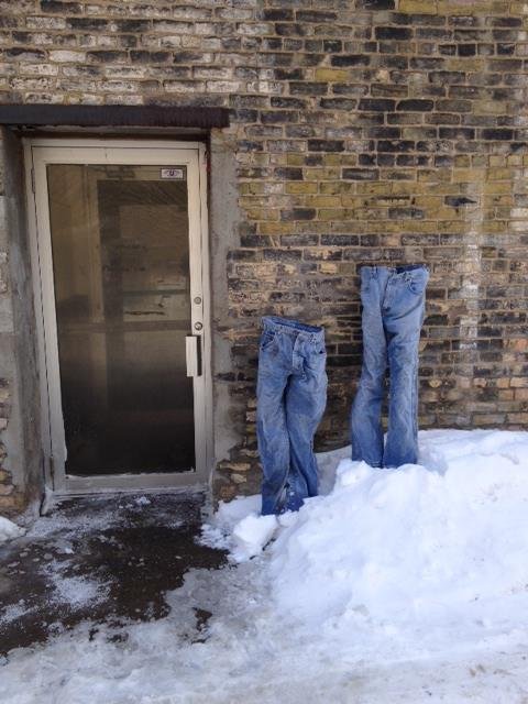 A Minnesota man has started a trend amongst Northeast Minneapolis homeowners after posting a photo to Facebook encouraging them to place frozen jeans as decorations on their front lawns.  Photo by Tom Grotting/Facebook