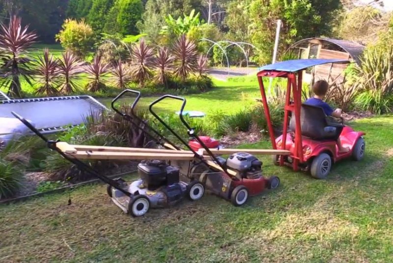 An Australian dad "hacked" his son's go-kart to create a homemade riding lawn mower. Screenshot: Newsflare