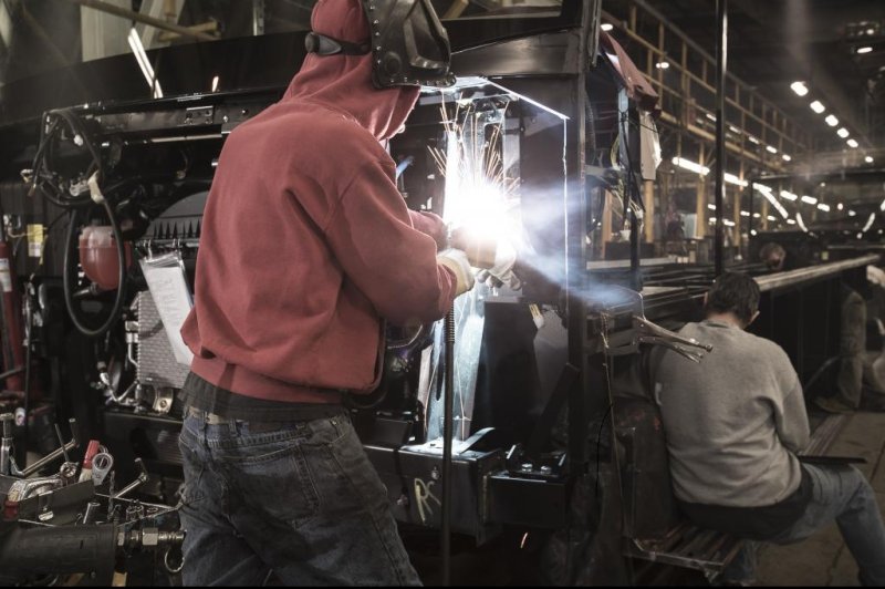A welder works on a recreational vehicle in a Winnebago factory. Photo courtesy Winnebago Industries