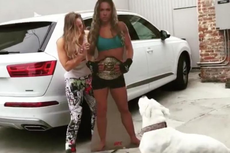 Ronda Rousey's dog hates her cardboard cutout, space shoes