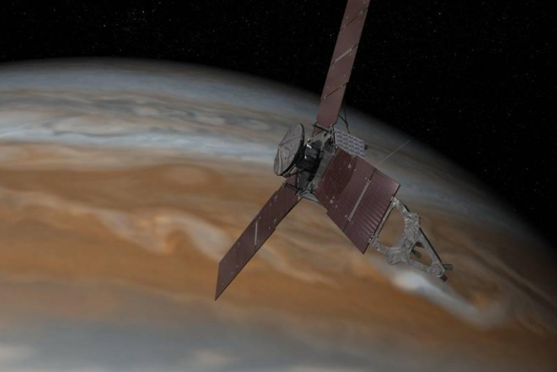 An illustration shows Juno entering into orbit around Jupiter, the largest planet in the solar system. Photo by NASA/JPL-Caltech