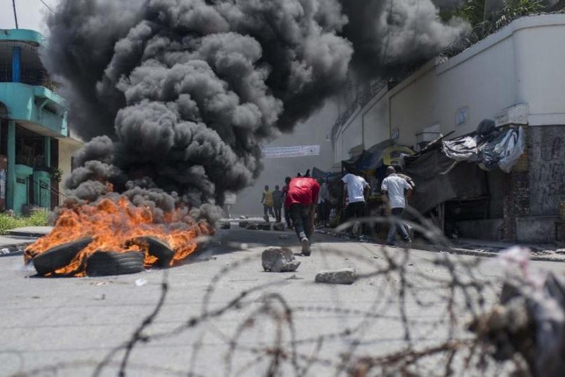 Demonstrators protesting a new budget that includes an increase in taxes burned cars and tires Tuesday in the streets of Port-au-Prince, Haiti. photo by Jean Marc Herve Abelard/EPA