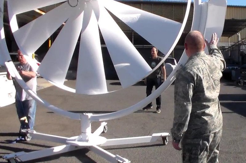 Natural Power Concepts personnel and Lt. Col. Scott Fitzner, of the AFRL Materials and Manufacturing Directorate, inspect the spoke wheel medium wind power system, one of a number of energy-harvesting technologies being installed as part of the five-year, $20 million cooperative agreement with AFRL that will establish a microgrid demonstration project at Joint Base Pearl Harbor-Hickam in Hawaii. (Courtesy photo/Hawaii Center for Advanced Transportation Technologies)