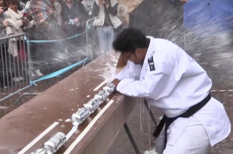 A martial artist from Pakistan set a Guinness World Record by crushing 77 drink cans using only his elbow.  Screen capture/Guinness World Records/YouTube