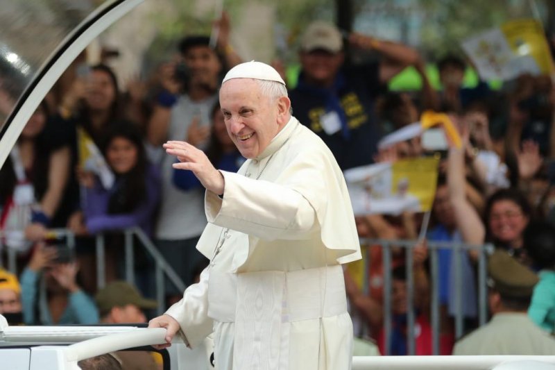 Pope Francis waves from the pope-mobile in Santiago, Chile, on Tuesday at the start of a three-day visit. Photo by Mauricio Duenas Castaneda/EPA