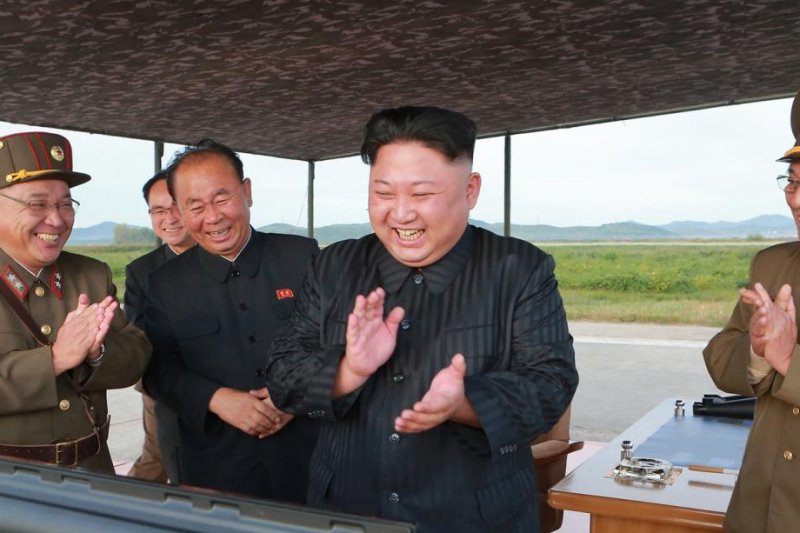 North Korea leader Kim Jong Un applaudssr the launch of the Hwasong-12 intermediate-range ballistic missile in this photo released by the North's official Korean Central News Agency on Sept. 16. File Photo by Yonhap