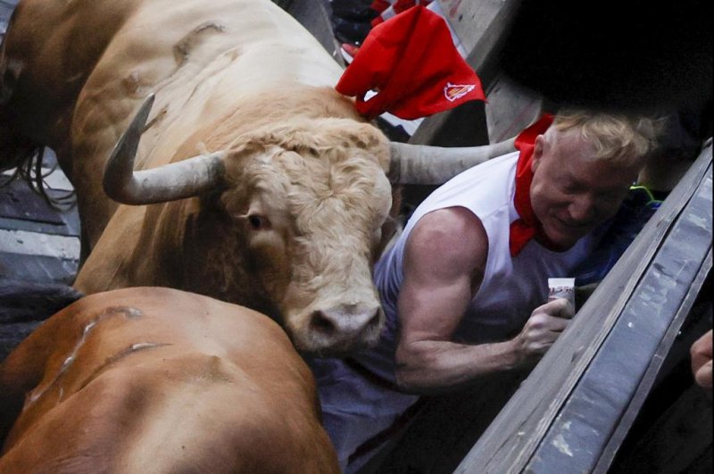 A man is hit by a charging bull during the traditional Running of the Bulls during the San Fermin Festival in Pamplona, Navarra, Spain Thursday, the first time the event is being held in two years after a hiatus because of the COVID-19 pandemic. Photo by Villar Lopez/EPA-EFE