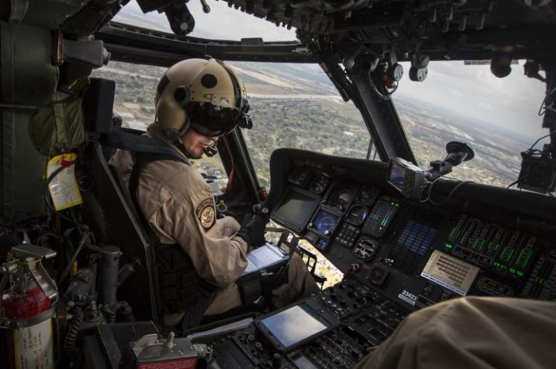 The UH-60 Black Hawk is designed to perform various missions including tactical troop transport, electronic warfare, and medical evacuations. Pictured: A U.S. Customs and Border Protection, Air and Marine Operations air interdiction agent pilots a UH-60 Black Hawk helicopter during an air-intercept training exercise. Photo by George Felton