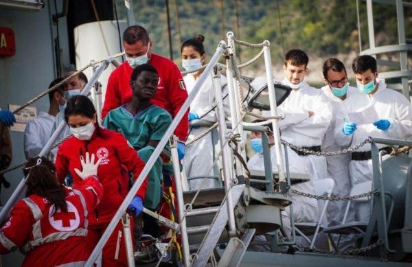 Migrants leave the Spanish ship Cantabria in the harbor of Salerno, Italy, on Sunday. During the rescue, 26 teenage girls were found dead. Photo by Cesare Abbate/EPA-EFE