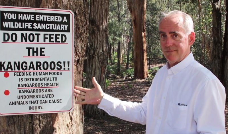 Lawmaker Greg Piper showing a warning sign to visitors not to feed the kangaroos in New South Wales, Australia. Photo courtesy Grep Piper/Facebook