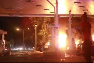 A gas station and auto-parts store were set fire Saturday night in a violent demonstration in Milwaukee after police fatally shot a man armed with a handgun during a foot chase. Screenshot by NBC News.