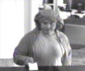 Eli Escalera, wearing a pair of shorts on his head, hands a bank teller a note. Photo: Monroe County Sheriff's Office.