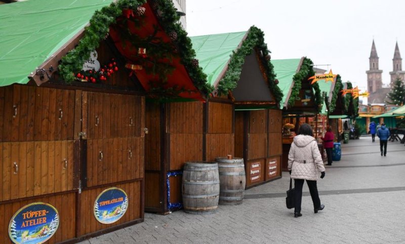 Pedestrians walk past the closed stalls of the Ludwigshafen, Germany, Christmas market Friday. 2016. A boy, 12, described by investigators as having Islamic State sympathies, allegedly attempted to attack the market and the town hall with a homemade explosive device Photo by Uwe Anspach/European Pressphoto Agency