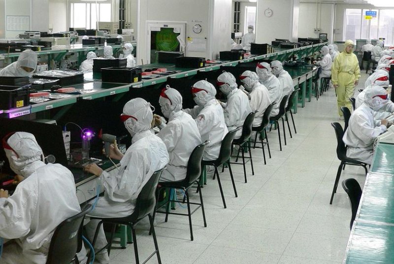 Foxconn factory workers in Shenzhen, China, photo-cure epoxy glue that holds fiber optic components in place in 2005. (CC/Steve Jurvetson)