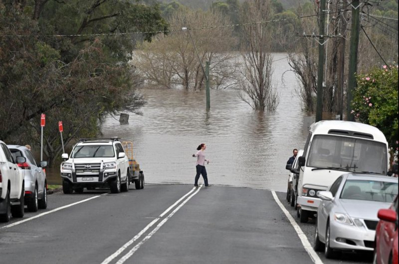 Floodwaters cut off a road in southwestern Sydney on Sunday after torrential rain and damaging winds hit New South Wales. Photo by Mick Tsikas/EPA-EFE
