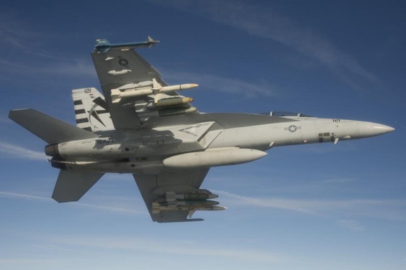 An F/A-18F Super Hornet assigned to the Salty Dogs of Air Test and Evaluation Squadron (VX) 23 conducts a captive carry flight test of an AGM-88E Advanced Anti-Radiation Guided Missile at Naval Air Station Patuxent River, Md. Photo by Greg L. Davis/U.S. Navy