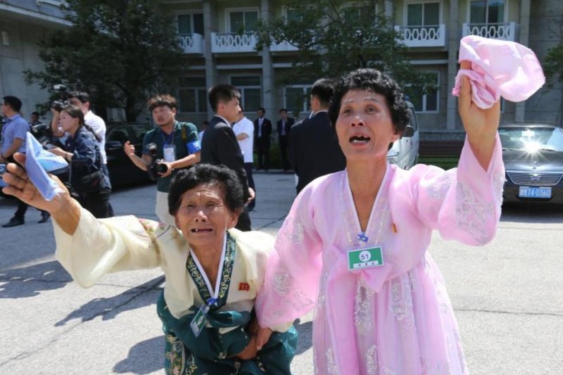 North Korean Ko Jeong-hui (L), 77, and Lee Gyeong-sun (R), 53, bid farewell to South Korean family member Lee Geum-yeon (not pictured), 87, at the Mount Kumgang resort, North Korea, in 2018. File Photo by O Jongchan/EPA-EFE