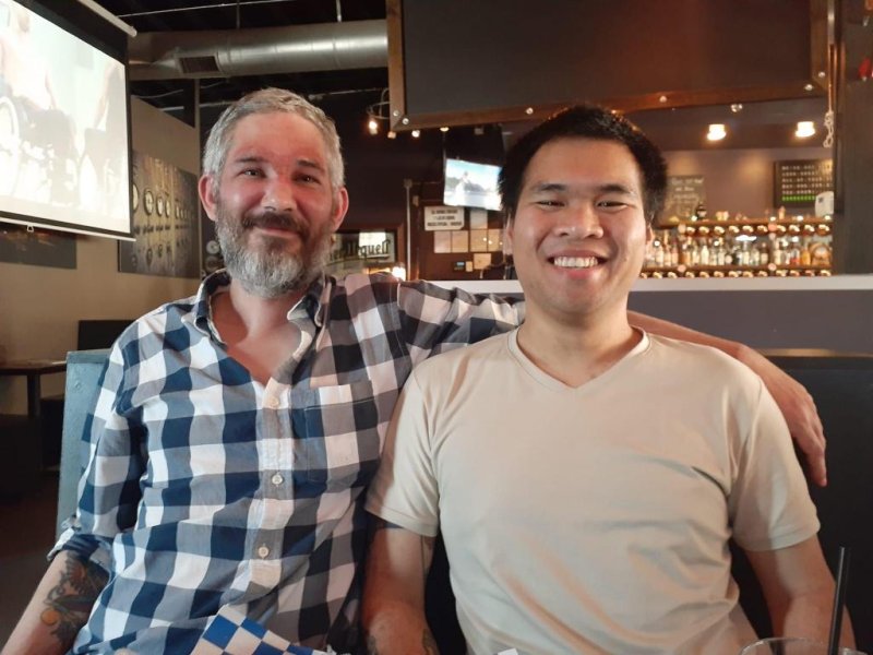 Alexander Drueke (L) and Andy Huynh pose for a photo at an Alabama bar. The pair were released from Russian captivity last week after being captured in June while fighting alongside Ukrainian forces. Photo courtesy of Dianna Shaw/<a href="https://praythemhome.net/2022/09/25/press-release-american-pows-released-from-russian-controlled-captivity-reunite-with-family-begin-recovery-9-25-22/">Release</a>